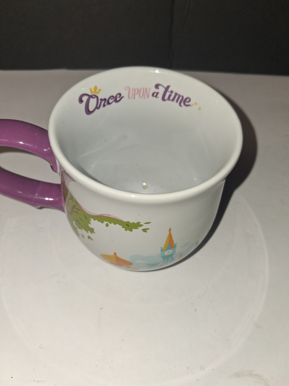 Disney Parks ceramic coffee mug featuring iconic castles from classic fairy tale